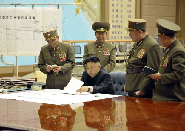 North Korean leader Kim Jong-un presides over an urgent operation meeting on the Korean People's Army Strategic Rocket Force's performance of duty for firepower strike at the Supreme Command in Pyongyang. The sign on the left reads, "Strategic force's plan to hit the mainland of the U.S.". REUTERS/KCNA