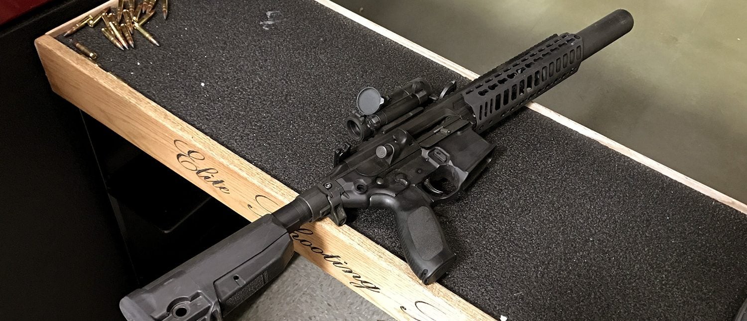 A suppressed SigSauer rifle rests on a bench at Elite Shooting Sports in Manassas, Va. Bobby Cox, director of government strategy at SigSauer, says the company makes suppressors for all its commercially available firearms. (PHOTO: Will Racke/TheDCNF)