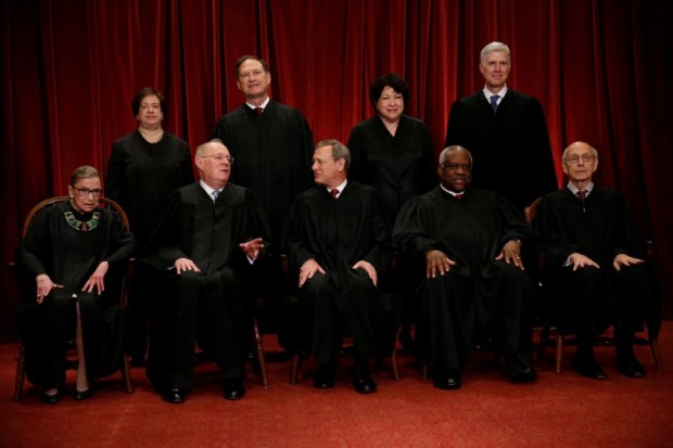 U.S. Chief Justice John Roberts (seated C) leads Justice Ruth Bader Ginsburg (front row, L-R), Justice Anthony Kennedy, Justice Clarence Thomas, Justice Stephen Breyer, Justice Elena Kagan (back row, L-R), Justice Samuel Alito, Justice Sonia Sotomayor, and Justice Neil Gorsuch in taking a new family photo including Gorsuch, their most recent addition, at the Supreme Court building in Washington, D.C., U.S., June 1, 2017. REUTERS/Jonathan Ernst