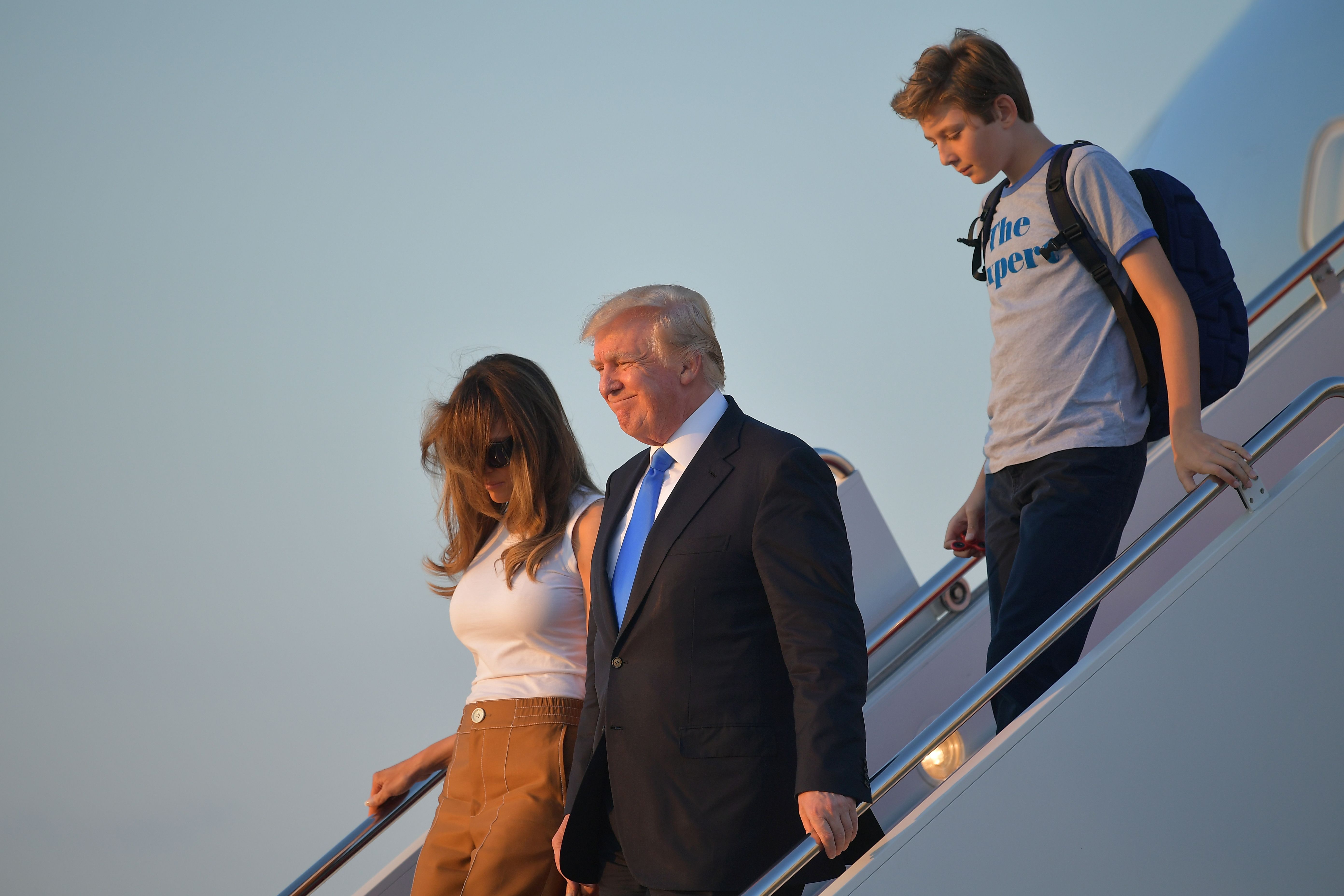 US President Donald Trump (C), first lady Melania Trump, and their son Barron Trump walk off Air Force One after arriving at Andrews Airforce base, Maryland on June 11 2017. Trump is returning to Washington, DC after spending the weekend at this Bedminster, New Jersey golf club. MANDEL NGAN/AFP/Getty Images