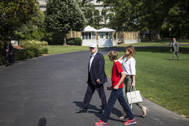 WASHINGTON, DC - JUNE 18: President Donald Trump and First Lady Melania Trump cross the South Lawn after arriving at The White House on June 18, 2017 in Washington, D.C. President Trump spent the weekend at Camp David. (Photo by Zach Gibson/Getty Images)