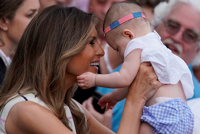 First Lady Melania Trump holds a baby as U.S. President Donald Trump (not pictured) greets members of the congress and their families as they attend a congressional picnic event at the White House in Washington, U.S., June 22, 2017. REUTERS/Carlos Barria TPX IMAGES OF THE DAY - RTS18A8B