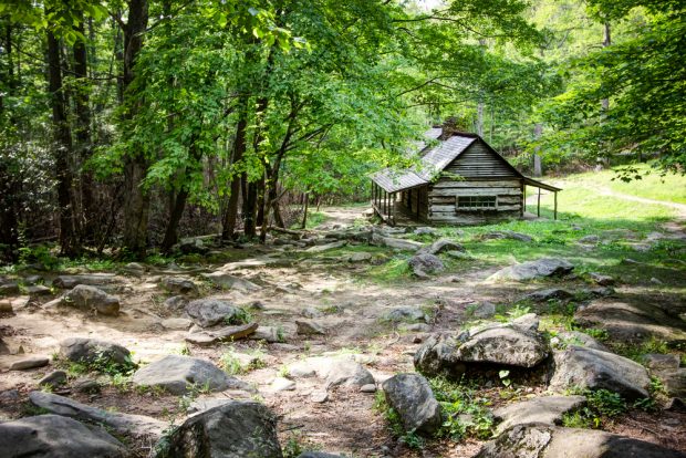 Pioneer Log Cabin. Log cabin in a lush mountain valley in the Great Smoky Mountains National Park. (Photo via Shutterstock)