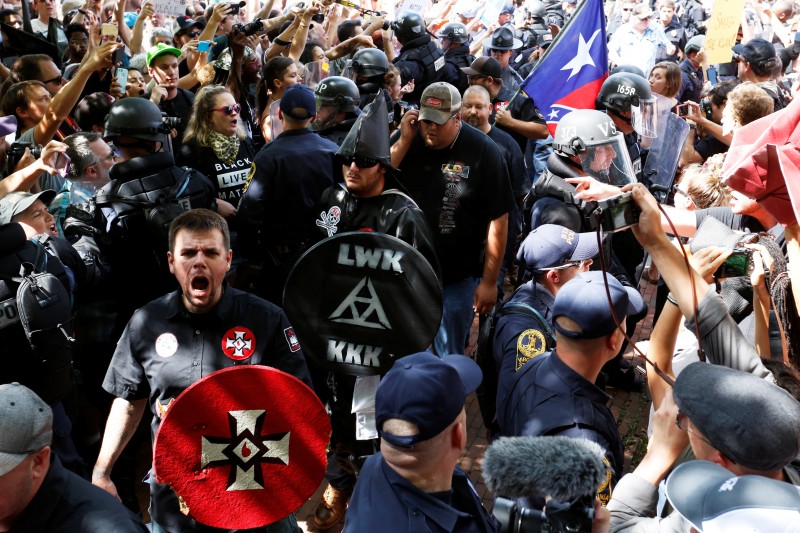 Riot police protect members of the Ku Klux Klan from counter-protesters as they arrive to rally in opposition to city proposals to remove or make changes to Confederate monuments in Charlottesville, Virginia, U.S. July 8, 2017. REUTERS/Jonathan Ernst