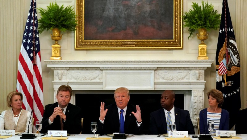 U.S. President Donald Trump speaks during a lunch meeting with Senate Republicans to discuss healthcare at the White House in Washington, U.S., July 19, 2017. From left are U.S. Senators Shelley Moore Capito (R-WV), Dean Heller (R-NV), Tim Scott (R-SC) and Lisa Murkowski (R-AK). REUTERS/Kevin Lamarque