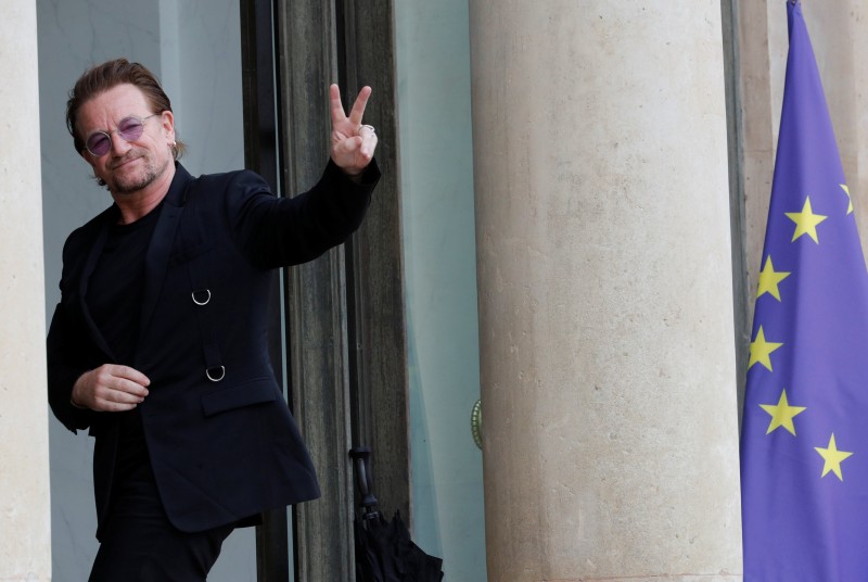 Singer Bono of Irish band U2 and co-founder of ONE organization waves as he arrives at the Elysee Palace in Paris, France, July 24, 2017. REUTERS/Philippe Wojazer