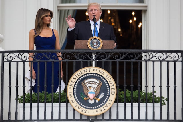 WASHINGTON, DC - JULY 4: U.S. President Donald Trump delivers remarks as first lady Melania Trump looks on from the Truman Balcony on July 4, 2017 in Washington, DC. The president was hosting a picnic for military families for the July 4 holiday. (Photo by Zach Gibson/Getty Images)