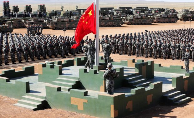 Soldiers of China's People's Liberation Army (PLA) raise a Chinese national flag during the military parade to commemorate the 90th anniversary of the foundation of the army at Zhurihe military training base in Inner Mongolia Autonomous Region, China, July 30, 2017. China Daily via REUTERS