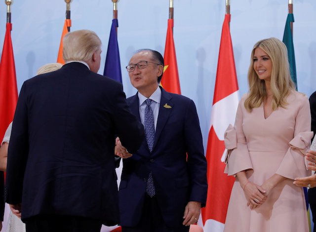 Ivanka Trumps looks on as U.S. President Donald Trump shakes hands with World Bank President Jim Yong Kim at the Womenís Entrepreneurship Finance event during the G20 leaders summit in Hamburg, Germany July 8, 2017. REUTERS/Carlos Barria - RTX3ALHC
