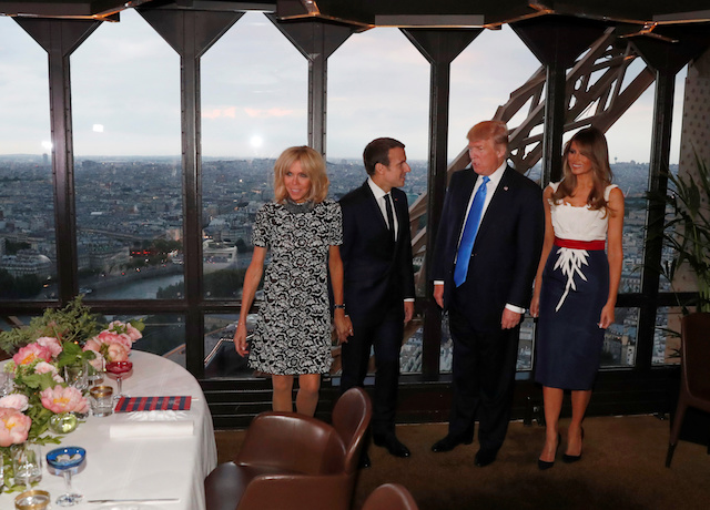 From L-R, Brigitte Macron, wife of French President Emmanuel Macron, U.S. President Donald Trump and First lady Melania Trump pose at the Jules Verne restaurant before a private dinner at the Eiffel Tower in Paris, France, July 13, 2107. REUTERS/Yves Herman - RTX3BD2W