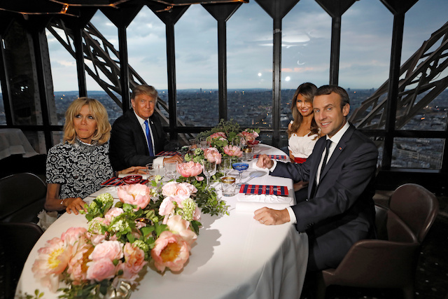 Brigitte Macron (L), wife of French President Emmanuel Macron (R), U.S. President Donald Trump (2ndL) and First lady Melania Trump pose at their table at the Jules Verne restaurant for a private dinner at the Eiffel Tower in Paris, France, July 13, 2107. REUTERS/Kevin Lamarque TPX IMAGES OF THE DAY - RTX3BD3T