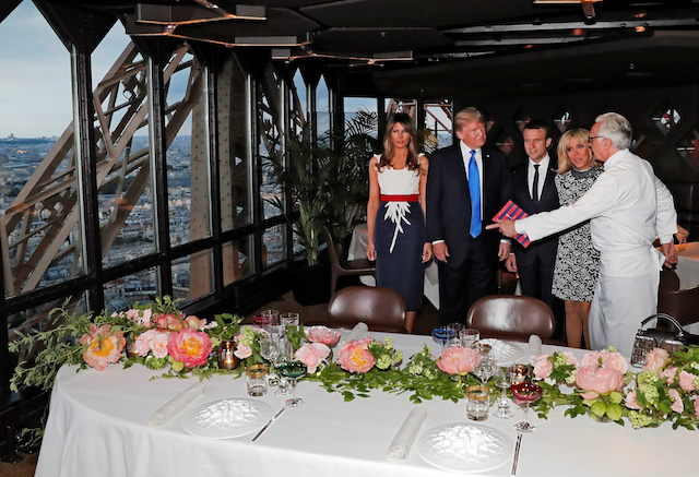 French chef Alain Ducasse (R) gestures as, from 2ndR, Brigitte Macron, wife of French President Emmanuel Macron, U.S. President Donald Trump and First lady Melania Trump gather at the Jules Verne restaurant before a private dinner at the Eiffel Tower in Paris, France, July 13, 2107. REUTERS/Yves Herman - RTX3BD4B