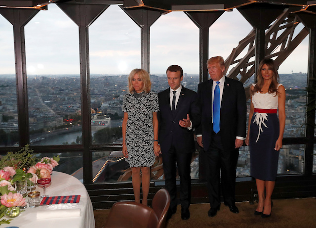 From L-R, Brigitte Macron, wife of French President Emmanuel Macron, U.S. President Donald Trump and First lady Melania Trump pose at the Jules Verne restaurant before a private dinner at the Eiffel Tower in Paris, France, July 13, 2107. REUTERS/Yves Herman - RTX3BD4M