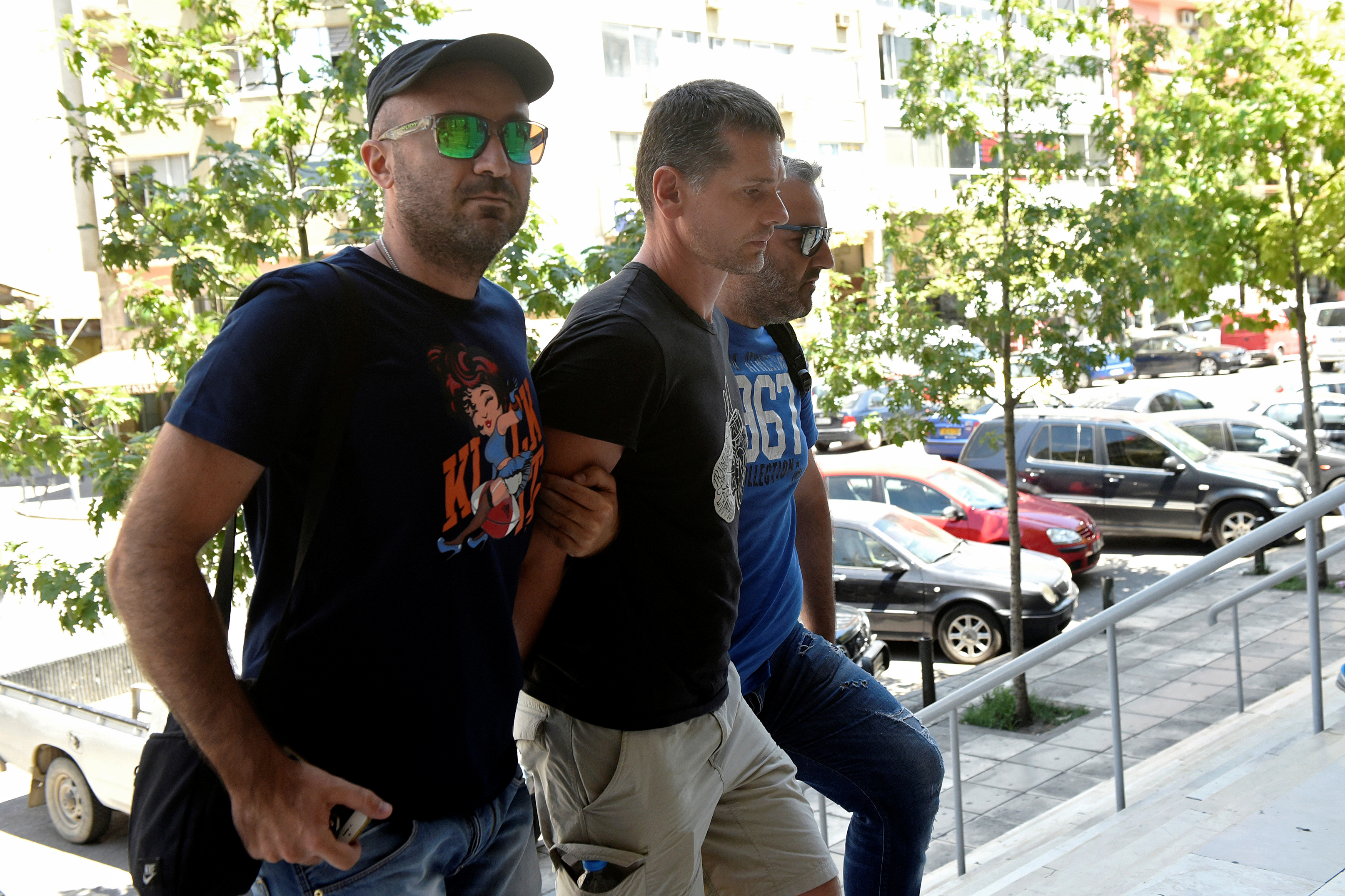 Alexander Vinnik, (C), is escorted by plain-clothes police officers to a court in Thessaloniki, Greece July 26, 2017. REUTERS/Alexandros Avramidis