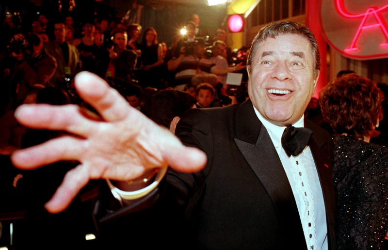 FILE PHOTO - Comedian Jerry Lewis reaches out to cover the camera lens as he arrives at the 12th annual American Comedy Awards, February 22, 1998 in Los Angeles where he was honored with the Lifetime Achievement Award. REUTERS/Stringer/File Photo