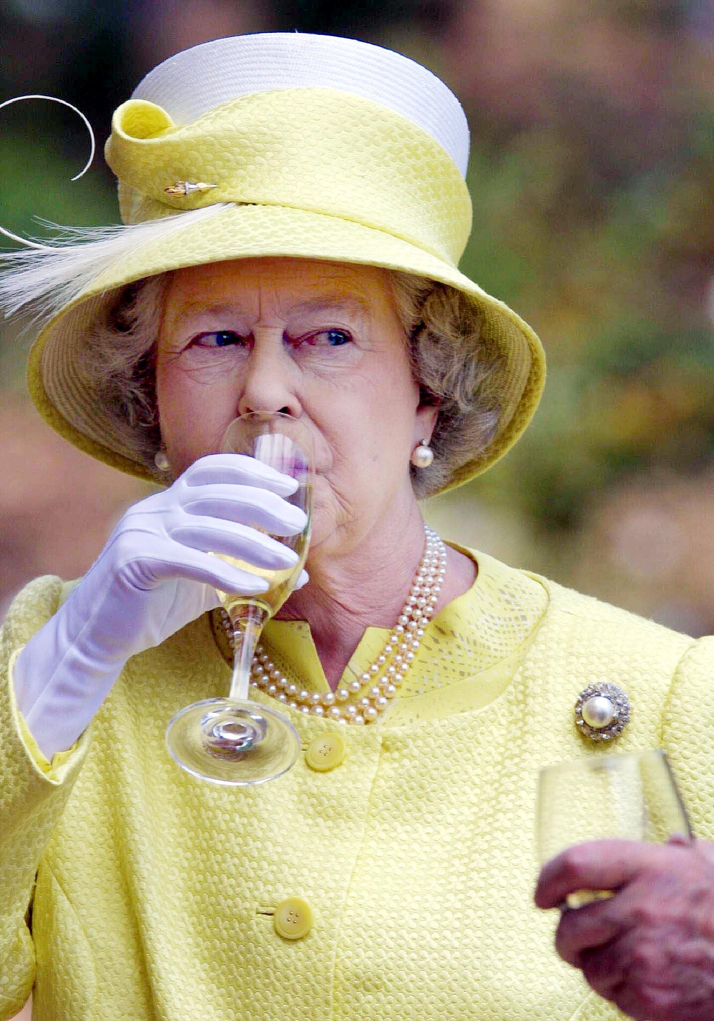 British's Queen Elizabeth II samples a Barrosa wine while visiting Chateau Barrosa in Adelaide, 28 February 2002. (Photo: RUSSEL MILLARD/AFP/Getty Images)