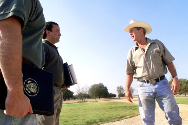 U.S. President George W. Bush talks with Deputy Chief of Staff Joe Hagin and deputy press secretary Scott McClellan on August 6, 2001 at his ranch in Crawford, Texas. (Photo by Eric Draper/White House/Getty Images)