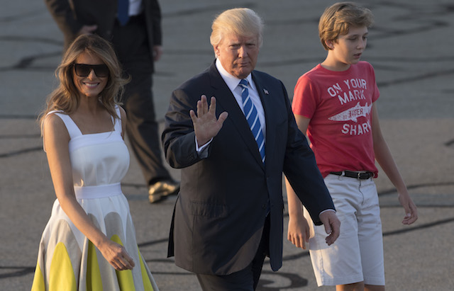 US President Donald Trump, First Lady Melania Trump and their son Barron, walk to board Air Force One prior to departure from Morristown Municipal Airport in Morristown, New Jersey, August 20, 2017, as Trump returns to Washington, DC, following a 17-day vacation at his property in Bedminster, New Jersey. / AFP PHOTO / SAUL LOEB (Photo credit should read SAUL LOEB/AFP/Getty Images)