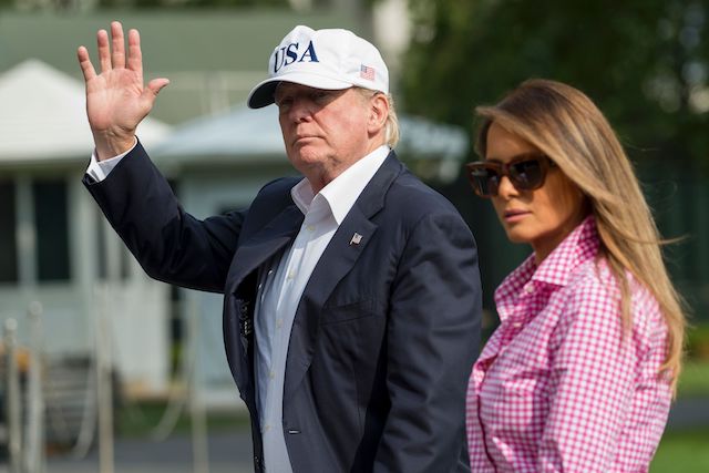 US President Donald Trump and First Lady Melanie Trump walk from Marine One upon arrival on the South Lawn of the White House in Washington, DC, August 27, 2017, after spending the weekend at Camp David, the Presidential retreat in Maryland. / AFP PHOTO / SAUL LOEB (Photo credit should read SAUL LOEB/AFP/Getty Images)
