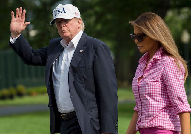 US President Donald Trump and First Lady Melanie Trump walk from Marine One upon arrival on the South Lawn of the White House in Washington, DC, August 27, 2017, after spending the weekend at Camp David, the Presidential retreat in Maryland. / AFP PHOTO / SAUL LOEB (Photo credit should read SAUL LOEB/AFP/Getty Images)