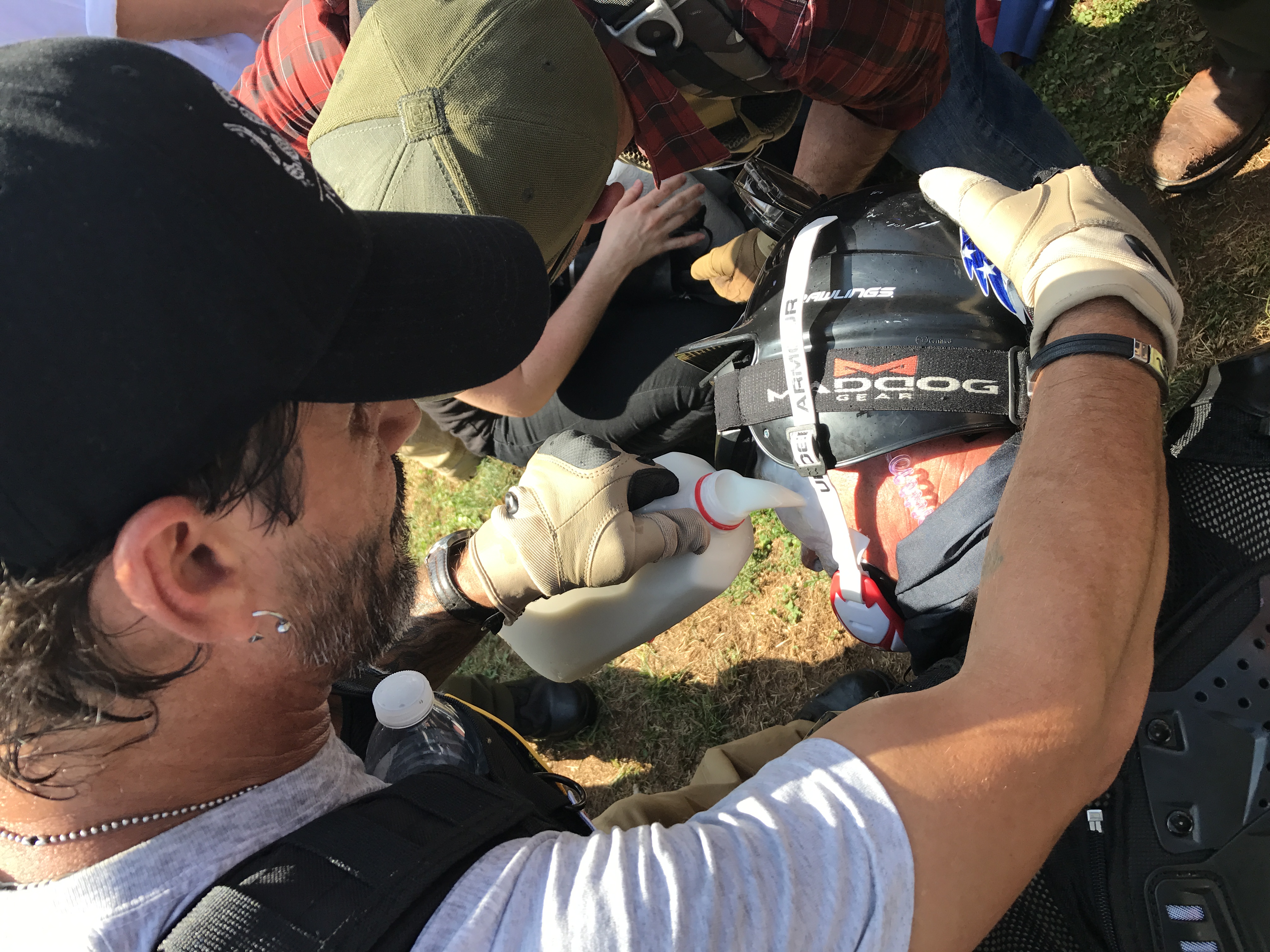 White supremacists poor milk onto the face of a member who was hit with tear gas. (Ted Goodman/TheDCNF)