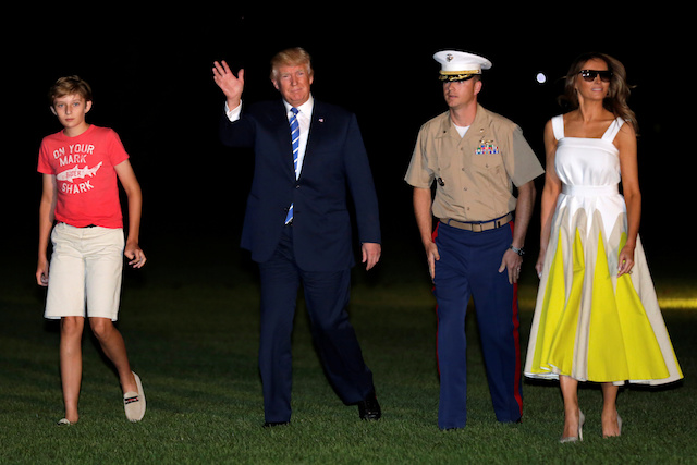 U.S. President Donald Trump waves as he walks with first lady Melania Trump and their son Barron on the South Lawn of the White House upon their return to Washington, U.S., after a vacation in Bedminster, NJ., August 20, 2017. REUTERS/Yuri Gripas - RTS1CKYL
