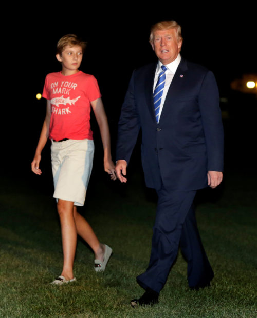 U.S. President Donald Trump walks with his son Barron on the South Lawn of the White House upon their return to Washington, U.S., after a vacation in Bedminster, NJ., August 20, 2017. REUTERS/Yuri Gripas - RTS1CKYR