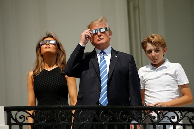 U.S. President Donald Trump watches the solar eclipse with first Lady Melania Trump and son Barron from the Truman Balcony at the White House in Washington, U.S., August 21, 2017. REUTERS/Kevin Lamarque - RTS1CPAK