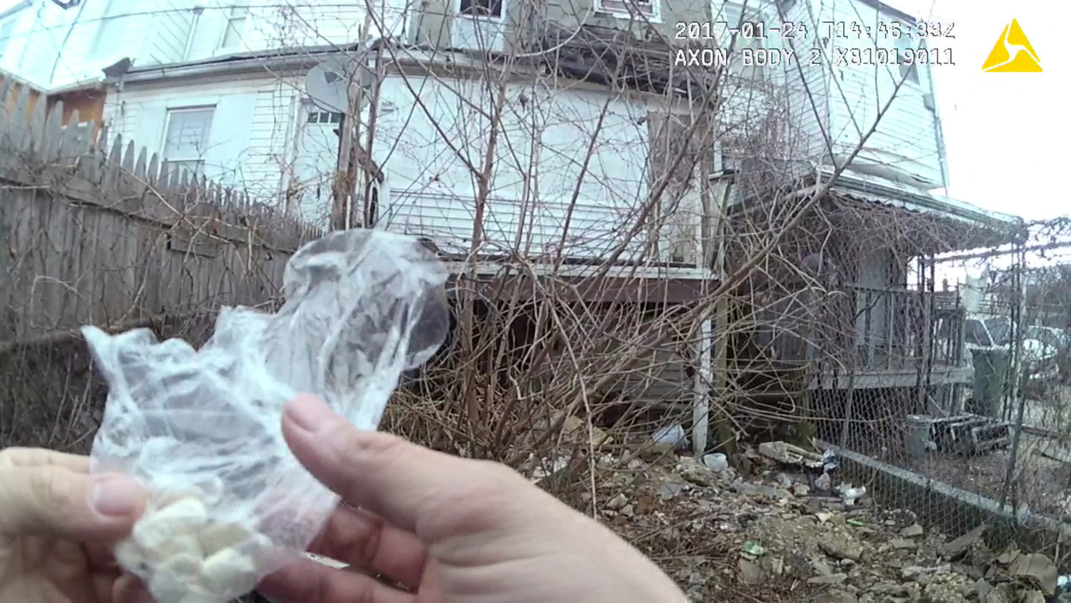 A still image captured from police body camera video appears to show a Baltimore police officer holding a small plastic bag filled with capsules which were filled with heroin powder in the arrest report, according to the Maryland Office of the Public Defender in this image released in Baltimore, Maryland, U.S. on July 19, 2017. Courtesy Baltimore Police Department/Handout via REUTERS