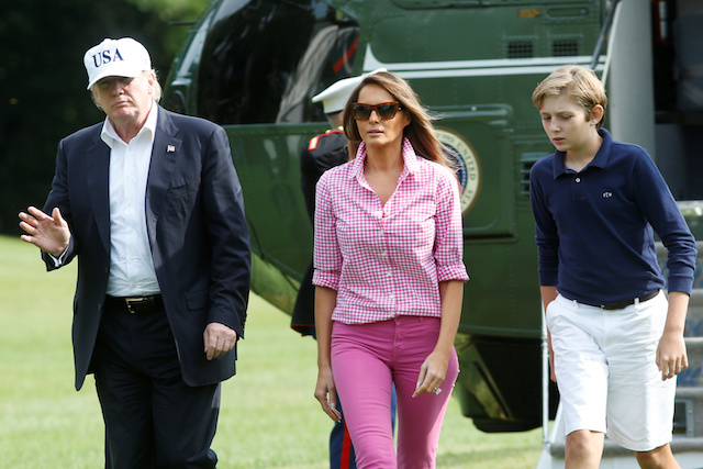 U.S. President Donald Trump waves as he with First Lady Melania Trump and their son Barron walk on South Lawn of the White House upon their return to Washington, U.S., from Camp David, August 27, 2017. REUTERS/Yuri Gripas - RTX3DKKZ