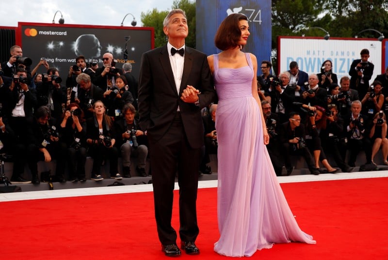 Actor and director George Clooney and his wife Amal pose during a red carpet event for the movie "Suburbicon" at the 74th Venice Film Festival in Venice, Italy September 2, 2017. REUTERS/Alessandro Bianchi