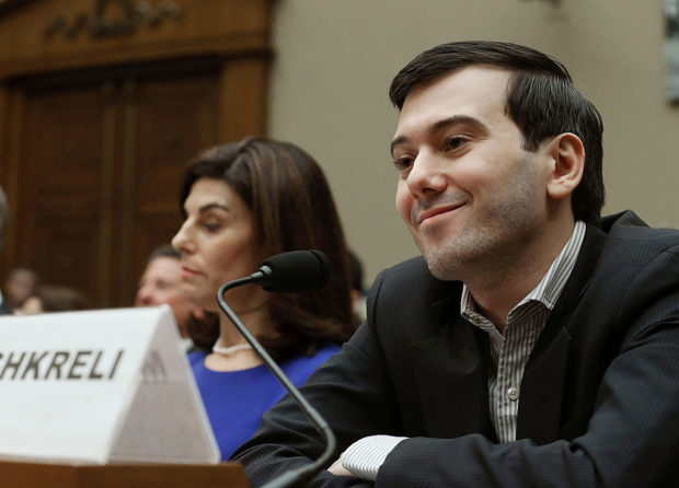 WASHINGTON, DC - FEBRUARY 04: Martin Shkreli, former CEO of Turing Pharmaceuticals LLC., smiles while flanked by Nancy Retzlaff, chief commercial officer for Turing Pharmaceuticals LLC., during a House Oversight and Government Reform Committee hearing on Capitol Hill, February 4, 2016 in Washington, DC. Mr. Shkreli invoked his 5th Amendment right not to testify to the committee that is examining the prescription drug market. (Photo by Mark Wilson/Getty Images)