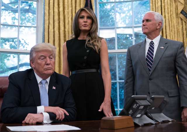 US First Lady Melania Trump speaks as President Donald Trump looks on after they received an update from disaster relief organizations on Hurricane Harvey recovery efforts in the Oval Office at the White House in Washington, DC, on September 1, 2017. / AFP PHOTO / NICHOLAS KAMM (Photo credit should read NICHOLAS KAMM/AFP/Getty Images)