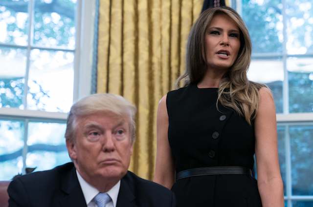 US First Lady Melania Trump speaks as President Donald Trump looks on after they received an update from disaster relief organizations on Hurricane Harvey recovery efforts in the Oval Office at the White House in Washington, DC, on September 1, 2017. / AFP PHOTO / NICHOLAS KAMM (Photo credit should read NICHOLAS KAMM/AFP/Getty Images)