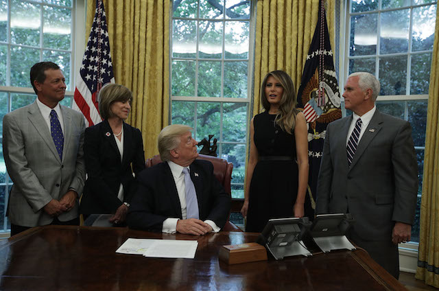 WASHINGTON, DC - SEPTEMBER 01: U.S. first lady Melania Trump (4th L) speaks as (L-R) President of North American Mission Board of Southern Baptist Convention Kevin Ezell, American Red Cross President & CEO Gail McGovern, President Donald Trump and Vice President Mike Pence look on in the Oval Office of the White House September 1, 2017 in Washington, DC. President Trump received an update from disaster relief organizations on Hurricane Harvey recovery efforts. (Photo by Alex Wong/Getty Images)