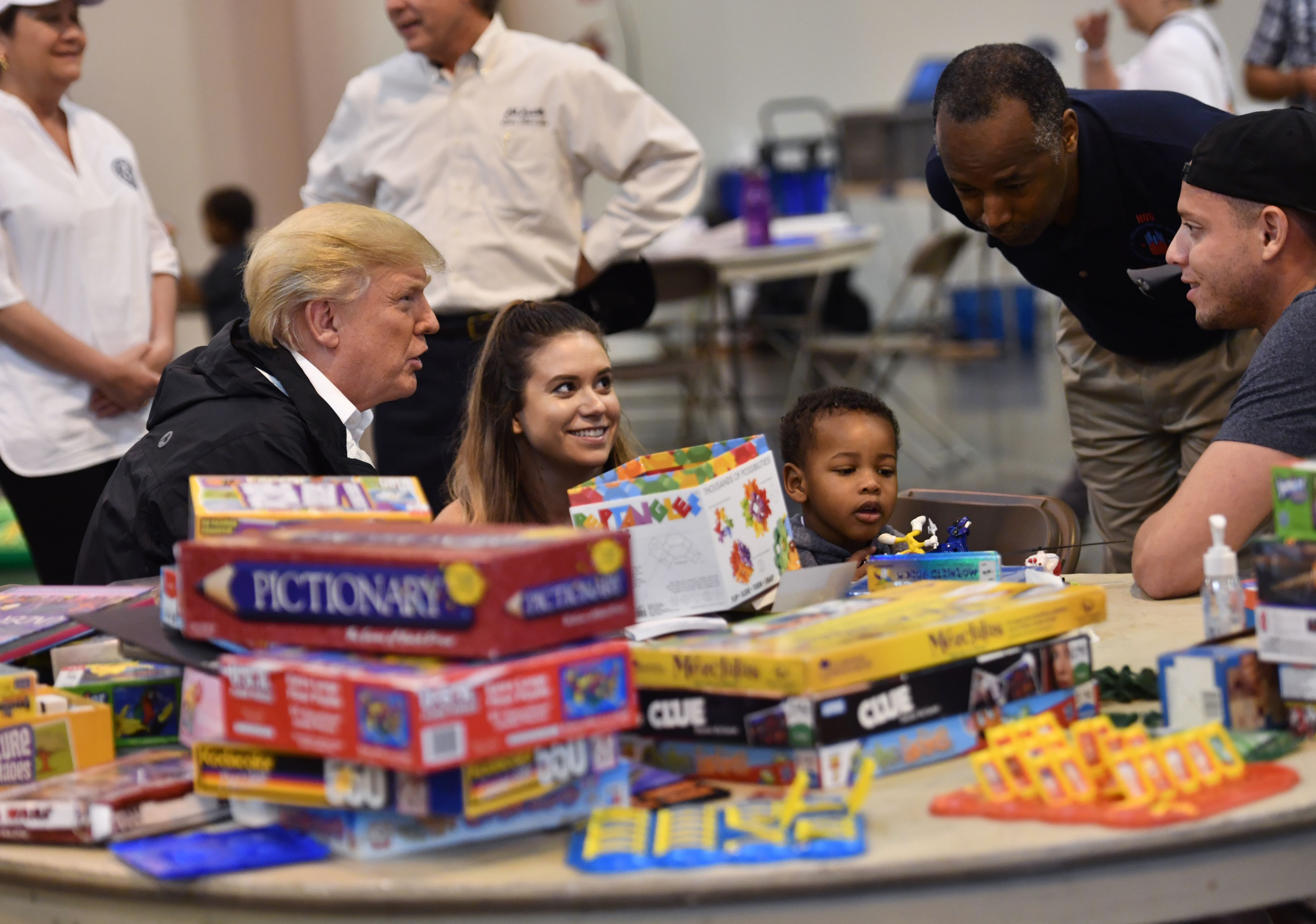 US President Donald Trump, with Secretary of Housing and Urban Development Ben Carson (2nd R), visits Hurricane Harvey victims at NRG Center in Houston on September 2, 2017. US President Donald Trump, with visits Hurricane Harvey victims at NRG Center in Houston on September 2, 2017. NICHOLAS KAMM/AFP/Getty Images
