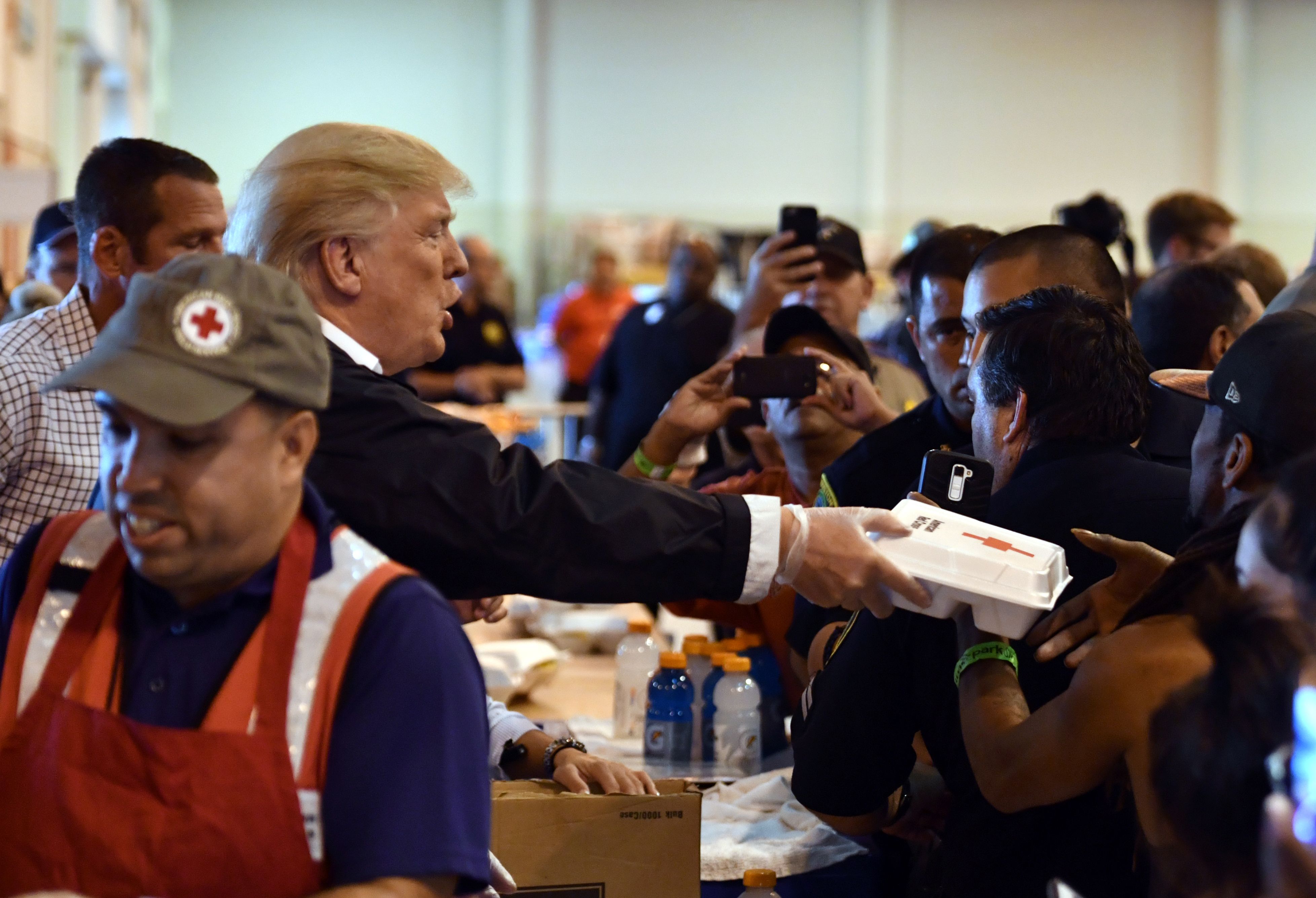 US President Donald Trump serves food to Hurricane Harvey victims at NRG Center in Houston on September 2, 2017. NICHOLAS KAMM/AFP/Getty Images