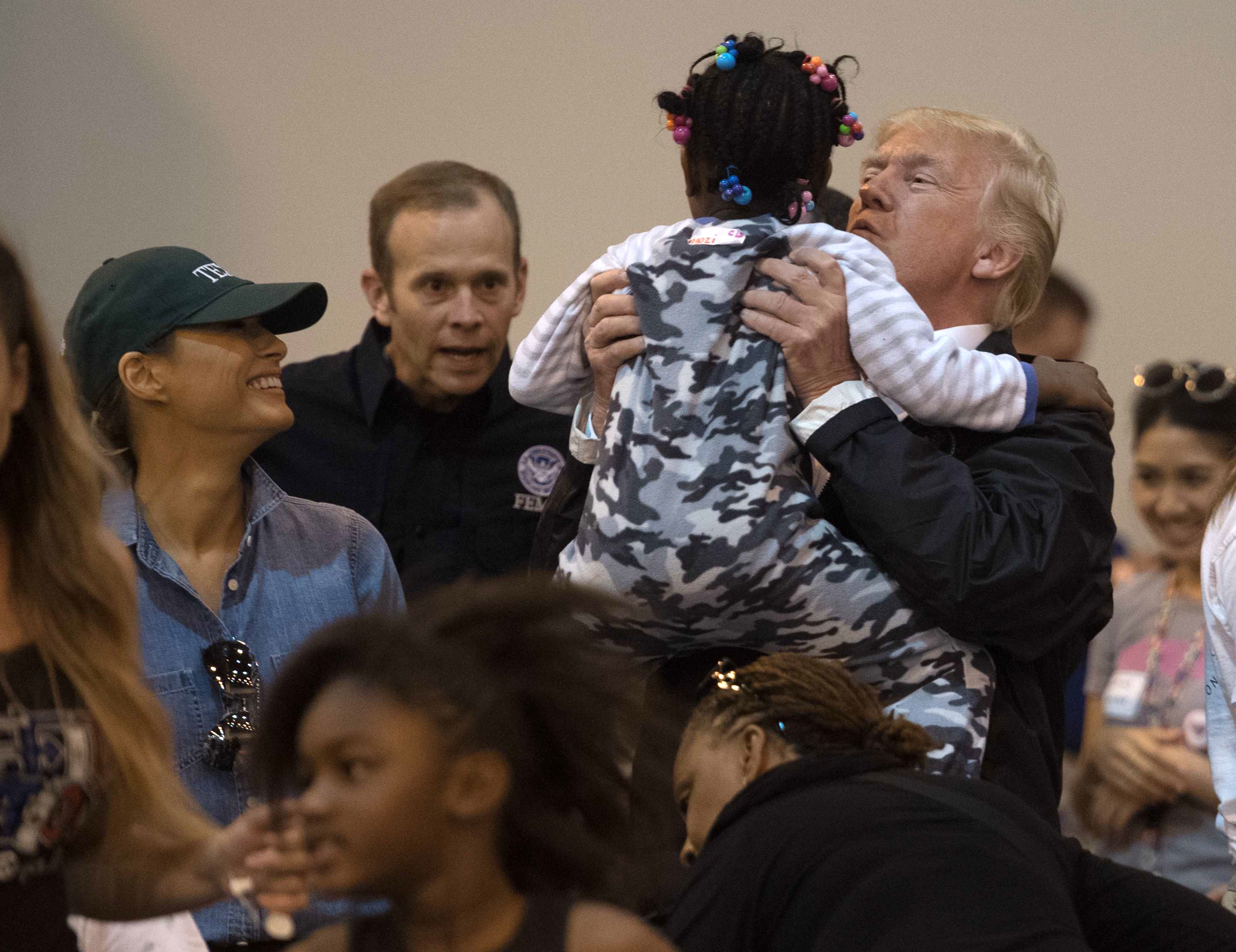 US President Donald Trump and First Lady Melania Trump greet a young Hurricane Harvey victim at NRG Center in Houston on September 2, 2017. NICHOLAS KAMM/AFP/Getty Images