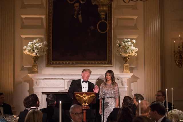 US President Donald Trump speaks beside First Lady Melania Trump beneath a portrait of 16th US president Abraham Lincoln as they host the White House Historical Association dinner at the White House in Washington, DC, on September 14, 2017. / AFP PHOTO / NICHOLAS KAMM (Photo credit should read NICHOLAS KAMM/AFP/Getty Images)