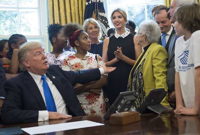 WASHINGTON, DC - SEPTEMBER 25: (AFP OUT) U.S. President Donald Trump motions to his daughter Ivanka Trump as she delivers remarks alongside students and members of congress and her father's administration, before President Trump signed a memorandum to expand access to STEM (science, technology, engineering and math) education in the Oval Office at the White House on September 25, 2017 in Washington, D.C. (Photo by Kevin Dietsch-Pool/Getty Images)