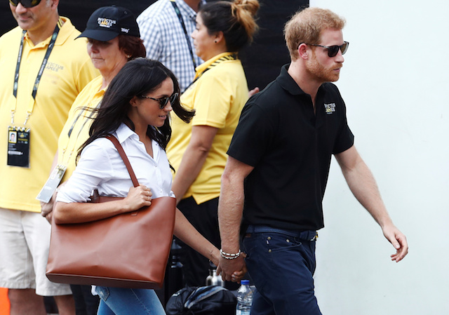 Britain's Prince Harry (R) arrives with girlfriend actress Meghan Markle at the wheelchair tennis event during the Invictus Games in Toronto, Ontario, Canada September 25, 2017. REUTERS/Mark Blinch -