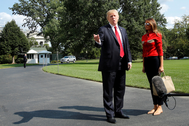 U.S. President Donald Trump talks to the media about Hurricane Irma next to first lady Melania Trump on the South Lawn the White House upon their return to Washington, U.S., from Camp David, September 10, 2017. REUTERS/Yuri Gripas - RC12E3191280