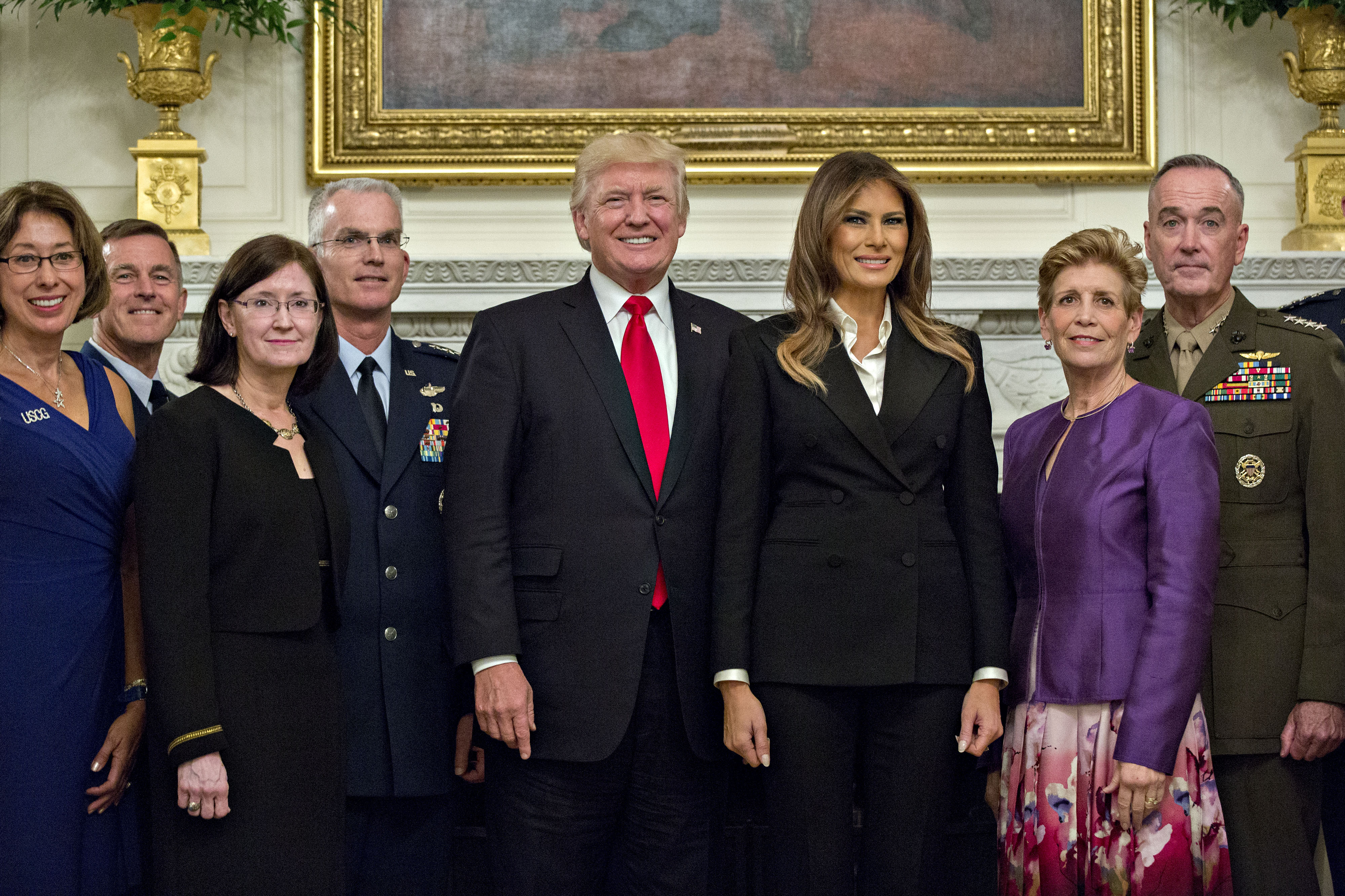 WASHINGTON, DC - OCTOBER 5: U.S. President Donald Trump and first lady Melania Trump pose for pictures with senior military leaders and spouses, including including Gen. Joseph Dunford (R), chairman of the joint chiefs of staff, and General Paul Selva (4th L), vice chairman of the joint chiefs of staff, after a briefing in the State Dining Room of the White House October 5, 2017 in Washington, D.C. The Trumps are hosting the group for a dinner in the Blue Room. (Photo by Andrew Harrer-Pool/Getty Images)