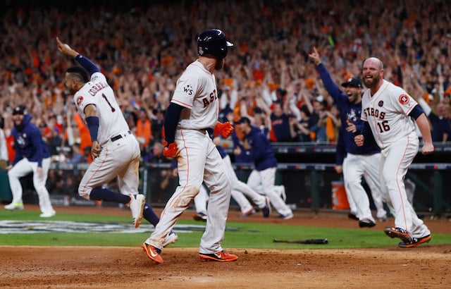 HOUSTON, TX - OCTOBER 30: Derek Fisher #21 of the Houston Astros celebrates with Brian McCann #16 after scoring the winning run during the tenth inning against the Los Angeles Dodgers in game five of the 2017 World Series at Minute Maid Park on October 30, 2017 in Houston, Texas. (Photo by Jamie Squire/Getty Images)
