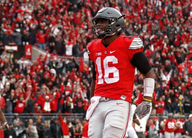 COLUMBUS, OH - NOVEMBER 26: J.T. Barrett #16 of the Ohio State Buckeyes celebrates after rushing for a touchdown in overtime against the Michigan Wolverines at Ohio Stadium on November 26, 2016 in Columbus, Ohio. (Photo by Gregory Shamus/Getty Images)