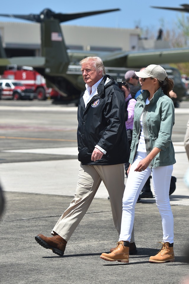 US President Donald Trump and First Lady Melania Trump arrive at Luis Muñiz Air National Guard Base in Carolina, Puerto Rico on October 3, 2017. President Donald Trump strenuously defended US efforts to bring relief to storm- battered Puerto Rico, even as one island official said Trump was trying to gloss over "things that are not going well," two weeks after devastating Hurricane Maria left much of the island without electricity, fresh water or sufficient food. / AFP PHOTO / HECTOR RETAMAL (Photo credit should read HECTOR RETAMAL/AFP/Getty Images)
