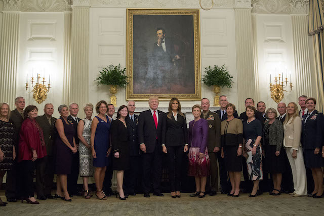 WASHINGTON, DC - OCTOBER 5: U.S. President Donald Trump and first lady Melania Trump pose for pictures with senior military leaders and spouses after a briefing in the State Dining Room of the White House October 5, 2017 in Washington, D.C. The Trumps are hosting the group for a dinner in the Blue Room. (Photo by Andrew Harrer-Pool/Getty Images)