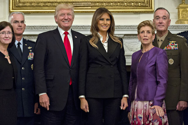 WASHINGTON, DC - OCTOBER 5: U.S. President Donald Trump and first lady Melania Trump pose for pictures with senior military leaders and spouses, including including Gen. Joseph Dunford (R), chairman of the joint chiefs of staff, and General Paul Selva (2nd L), vice chairman of the joint chiefs of staff, after a briefing in the State Dining Room of the White House October 5, 2017 in Washington, D.C. The Trumps are hosting the group for a dinner in the Blue Room. (Photo by Andrew Harrer-Pool/Getty Images)