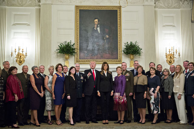 WASHINGTON, DC - OCTOBER 5: U.S. President Donald Trump and first lady Melania Trump pose for pictures with senior military leaders and spouses after a briefing in the State Dining Room of the White House October 5, 2017 in Washington, D.C. The Trumps are hosting the group for a dinner in the Blue Room. (Photo by Andrew Harrer-Pool/Getty Images)