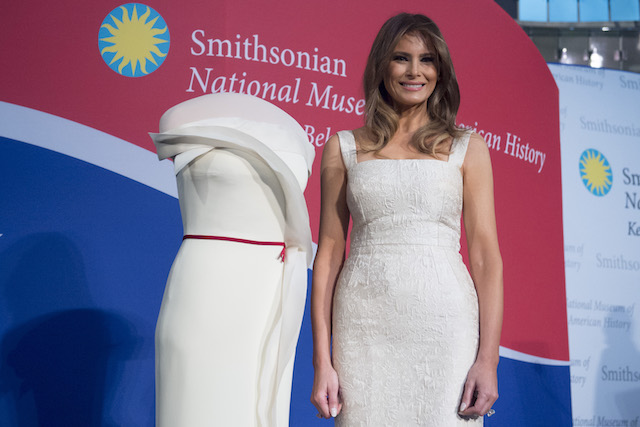 US First Lady Melania Trump stands alongside the gown she wore to the 2017 inaugural balls as she donates the dress to the Smithsonian's First Ladies Collection at the Smithsonian National Museum of American History in Washington, DC, October 20, 2017. / AFP PHOTO / SAUL LOEB (Photo credit should read SAUL LOEB/AFP/Getty Images)